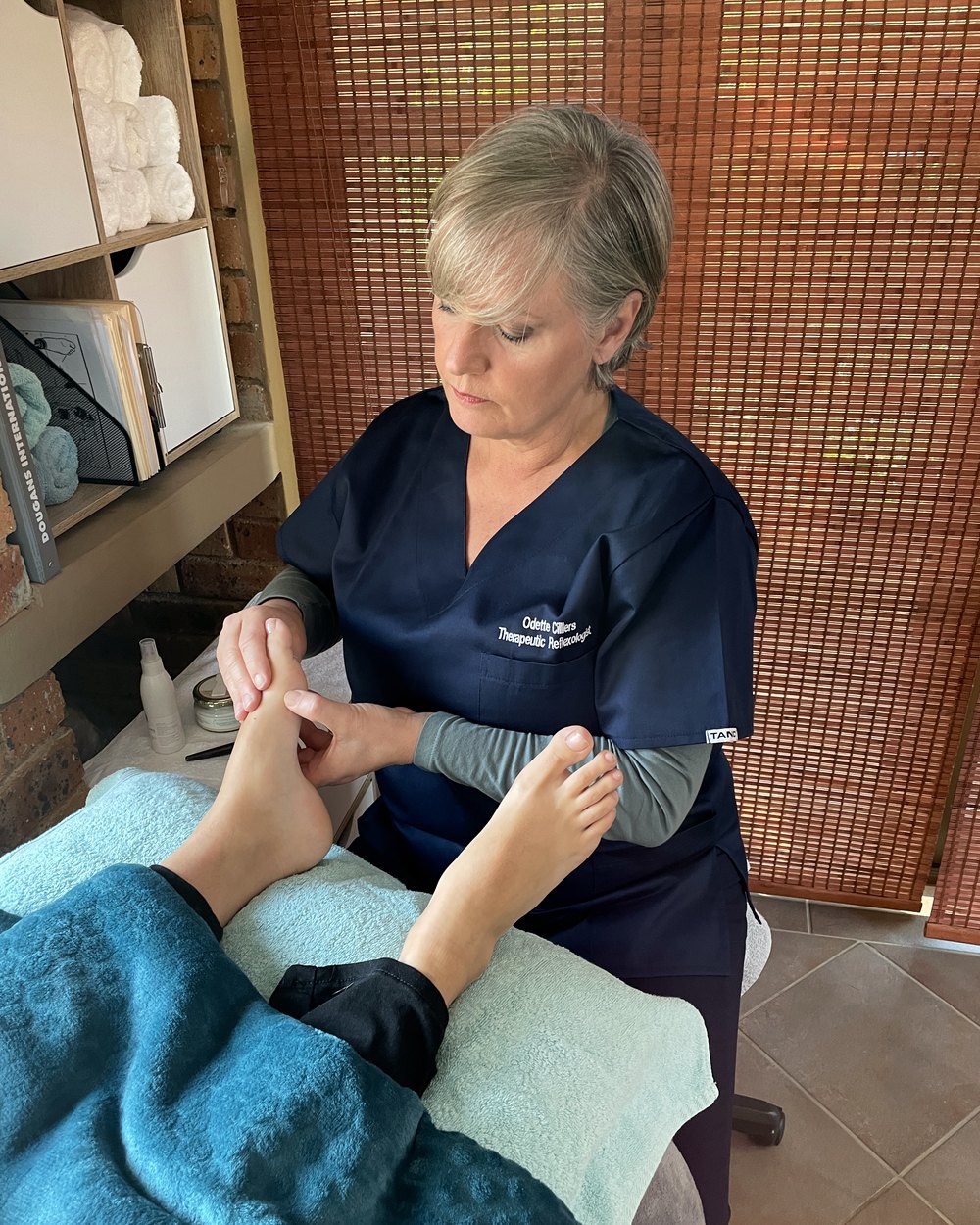 Odette Cilliers, Registered Therapeutic Reflexologist, working with a client at the practice